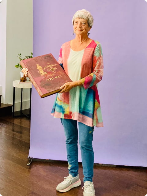 Older woman holding a book published by the Confederate Army during the US Civil War